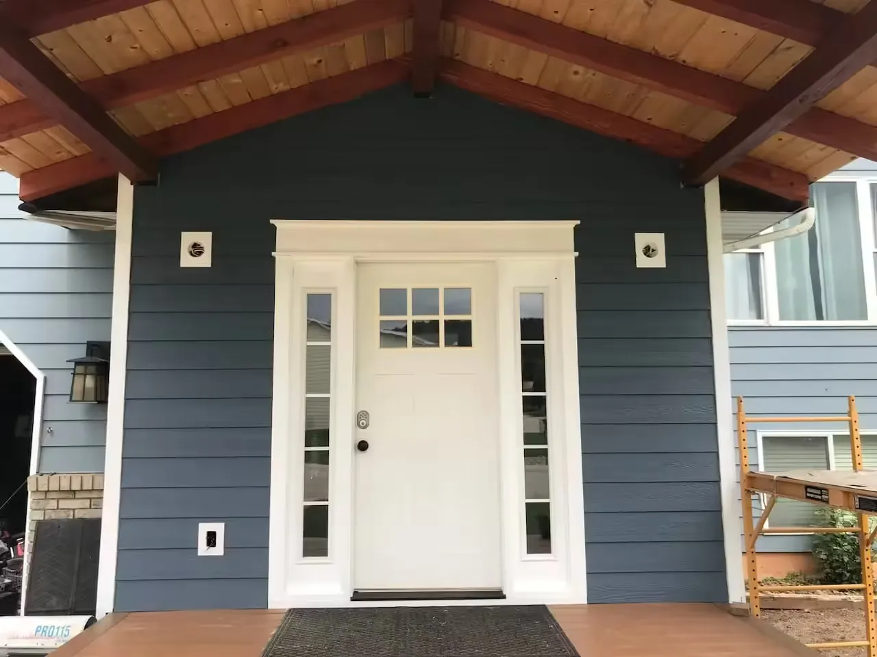 New deck, patio, door, and overhang.